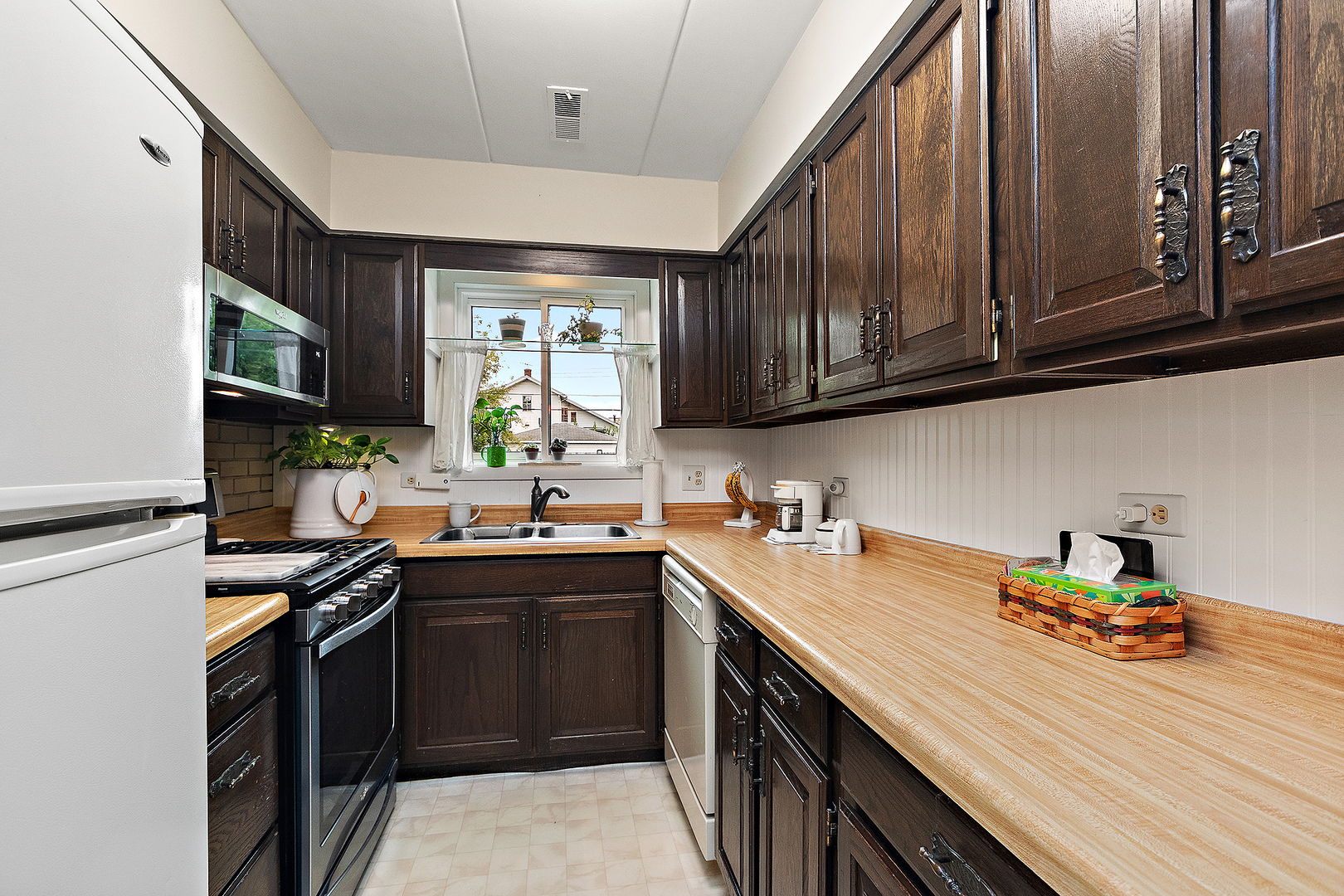 1940 183rd Street, Unit 1C Homewood, IL 60430 - Photo 4 of 16 a kitchen with a sink a stove cabinets and a window
