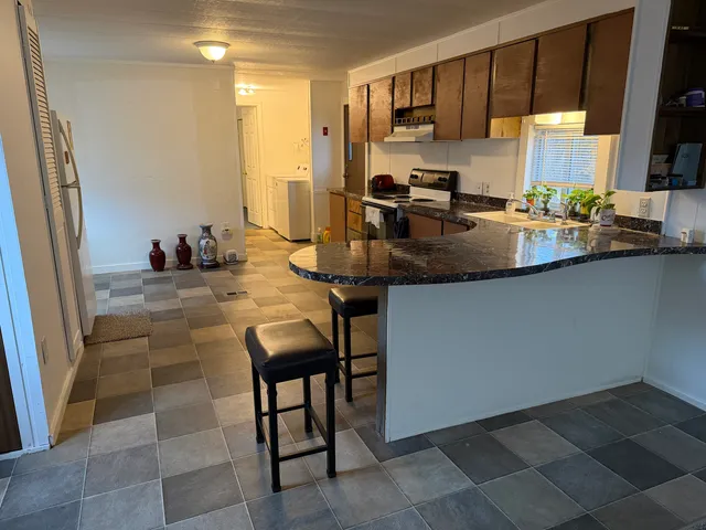 a view of a storage & utility room with two washing machine