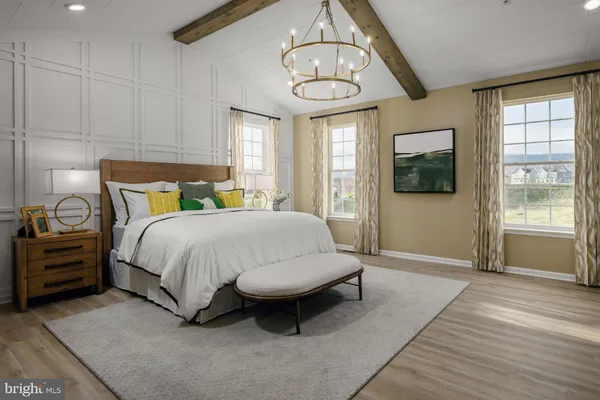 a spacious bedroom with a bed a window and flat screen tv