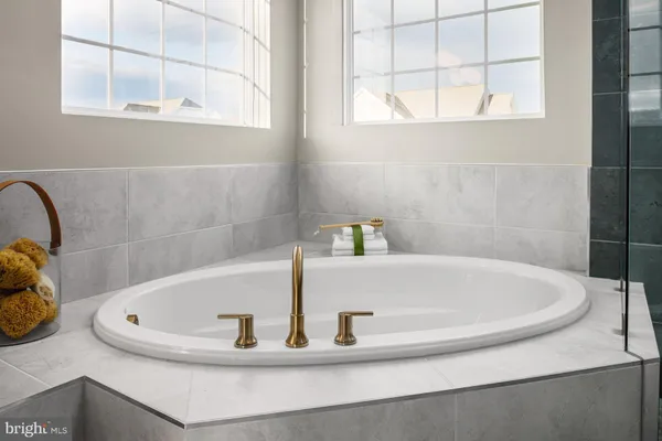 a bathroom with a tub and a window