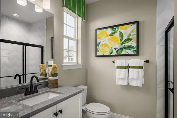a bathroom with a sink a mirror and a toilet