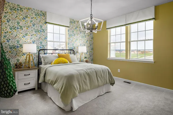 a spacious bedroom with a bed and window