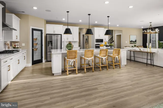 a large kitchen with cabinets and wooden floor