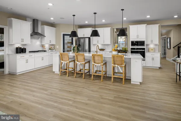 a large white kitchen with lots of counter space and appliances