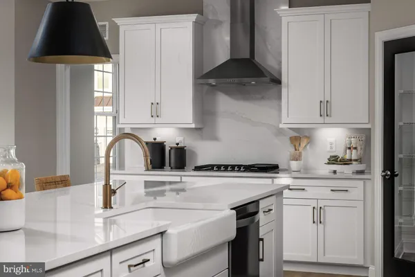 a kitchen with a sink a stove and cabinets