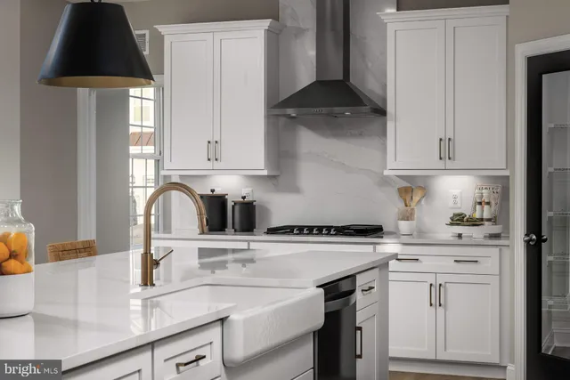 a kitchen with a sink a stove and cabinets