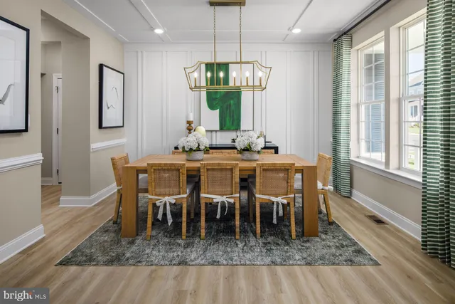 a dining room with furniture a rug and wooden floor