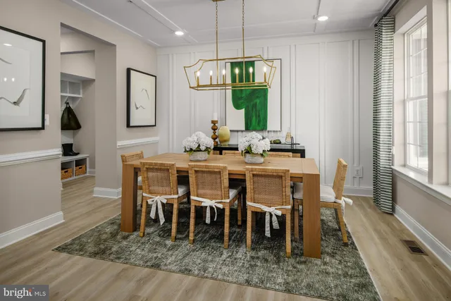 a dining room with furniture a rug and wooden floor