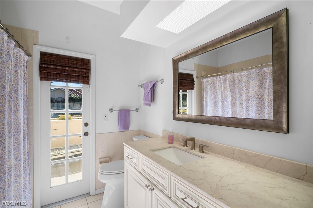 11772 Mahogany Run Fort Myers, FL 33913 - Photo 33 of 50 a bathroom with a granite countertop sink toilet and shower