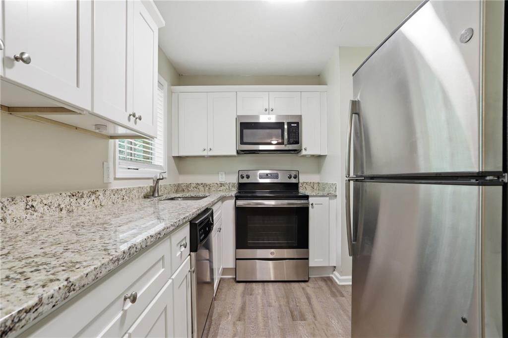 4505 Wonder Valley Trail Decatur, GA 30034 - Photo 8 of 34 a kitchen with granite countertop a refrigerator stove and sink
