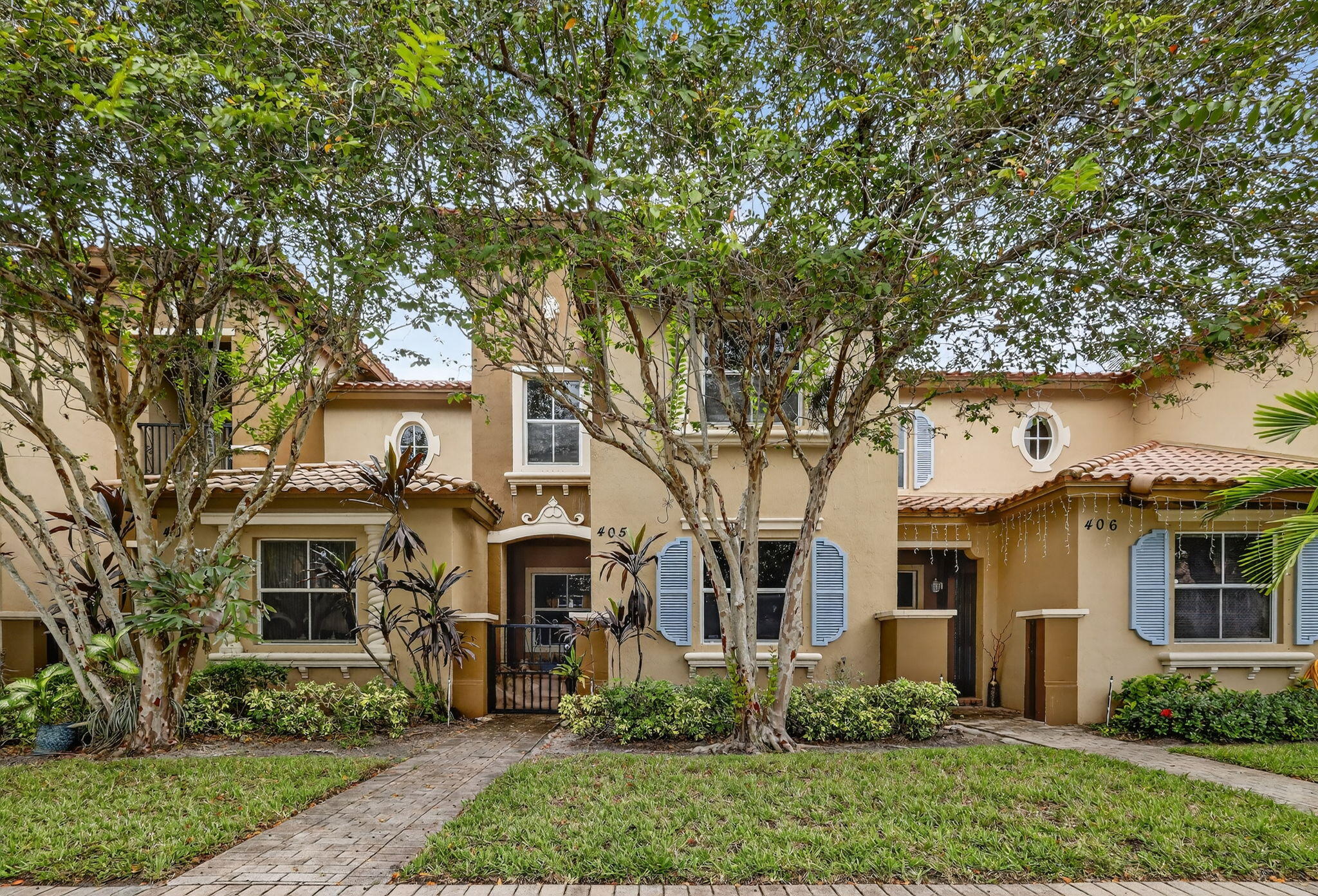 2931 Hope Valley Street, Unit 405 West Palm Beach, FL 33411 - Photo 1 of 35 front view of a house with a tree