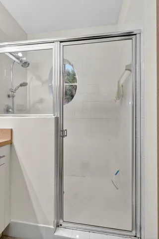 a bathroom with a glass shower door