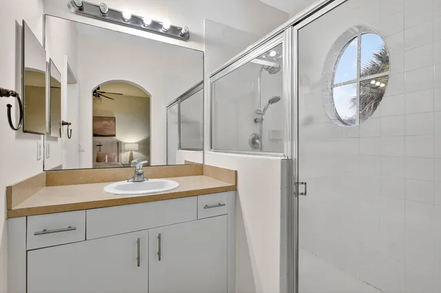 a bathroom with a granite countertop sink mirror and vanity