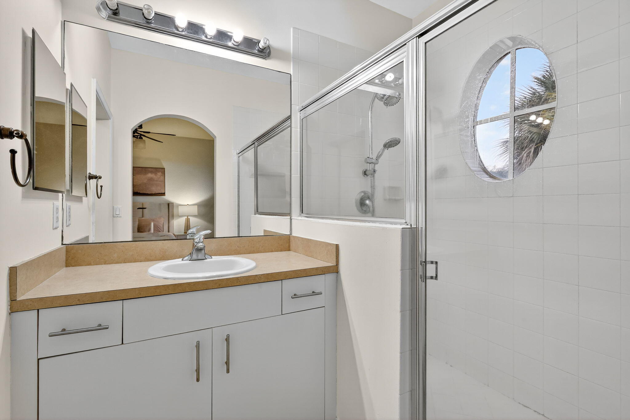 2931 Hope Valley Street, Unit 405 West Palm Beach, FL 33411 - Photo 24 of 35 a bathroom with a granite countertop sink mirror and vanity