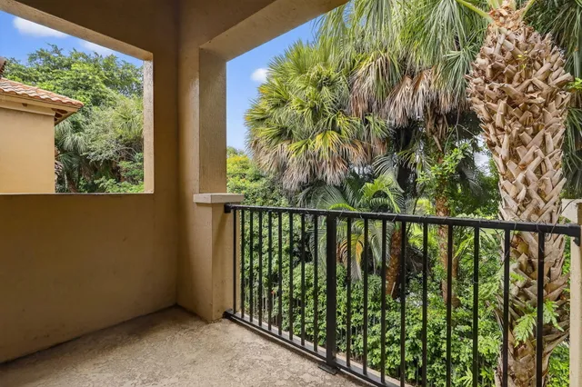 a balcony with trees in front of it