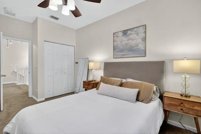 a bedroom with a bed and a lamp