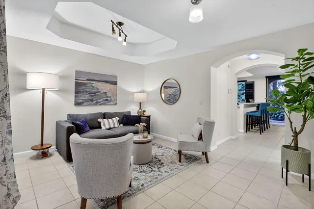 a living room with furniture and a lamp