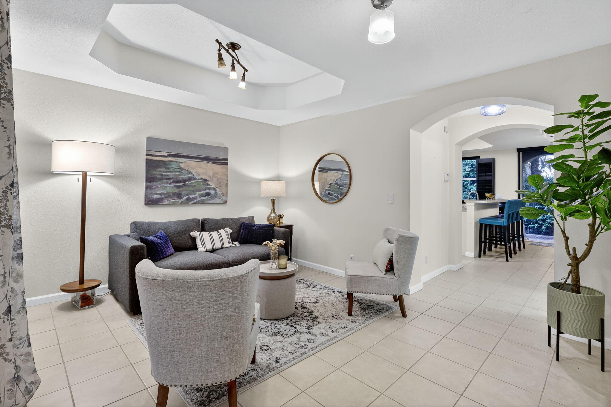 2931 Hope Valley Street, Unit 405 West Palm Beach, FL 33411 - Photo 6 of 35 a living room with furniture and a lamp