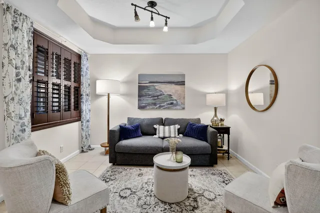 a living room with furniture a rug and a window