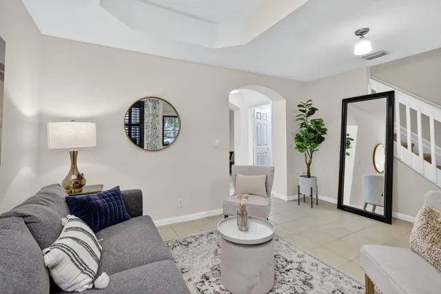 a living room with furniture and a painting on the wall