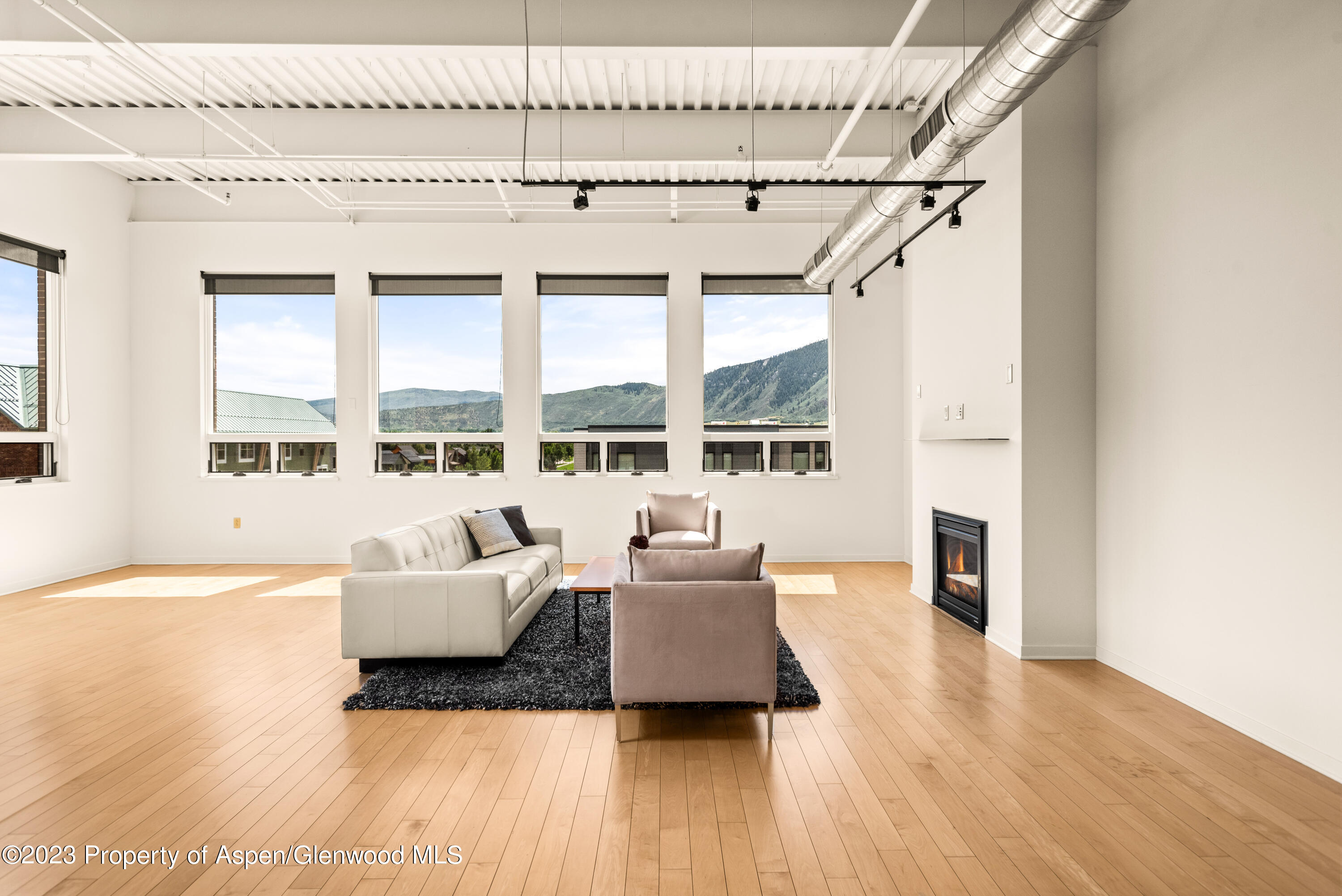 361 Robinson Street, Unit 326 Basalt, CO 81621 - Photo 3 of 10 a living room with furniture and a large window