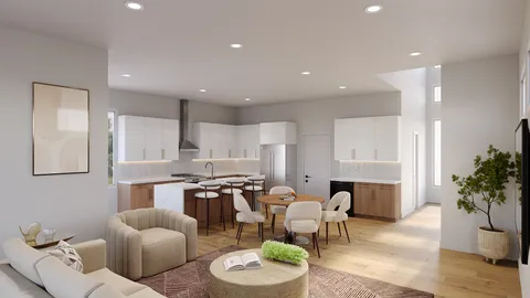 a living room with furniture kitchen view and a potted plant