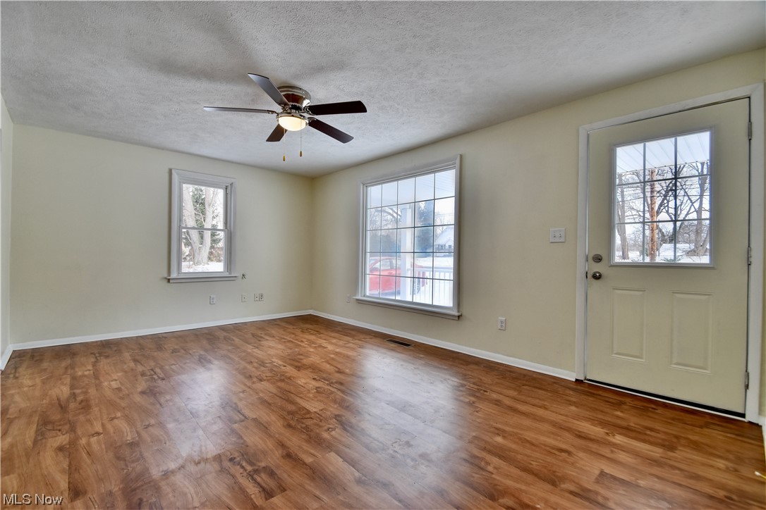 1512 Hubbard Road Madison, OH 44057 - Photo 22 of 27 Entrance foyer featuring a textured ceiling, hardwood / wood-style flooring, and ceiling fan