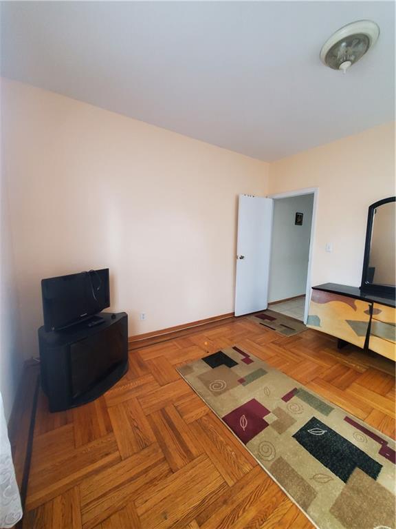 1053 East 13th Street, Unit B1 Brooklyn, NY 11230 - Photo 11 of 17 a bedroom with a bed and a lamp