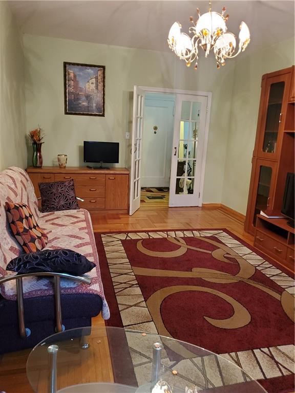 1053 East 13th Street, Unit B1 Brooklyn, NY 11230 - Photo 4 of 17 a bedroom with furniture and a chandelier