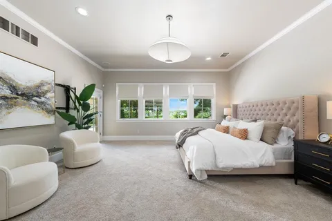 a spacious bedroom with a bed and a window