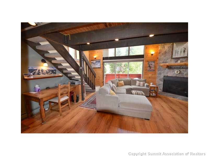 78 Guller Road, Unit 212 Frisco, CO 80443 - Photo 6 of 23 Living Room. The living room leads to the condo s open deck & breathtaking views!