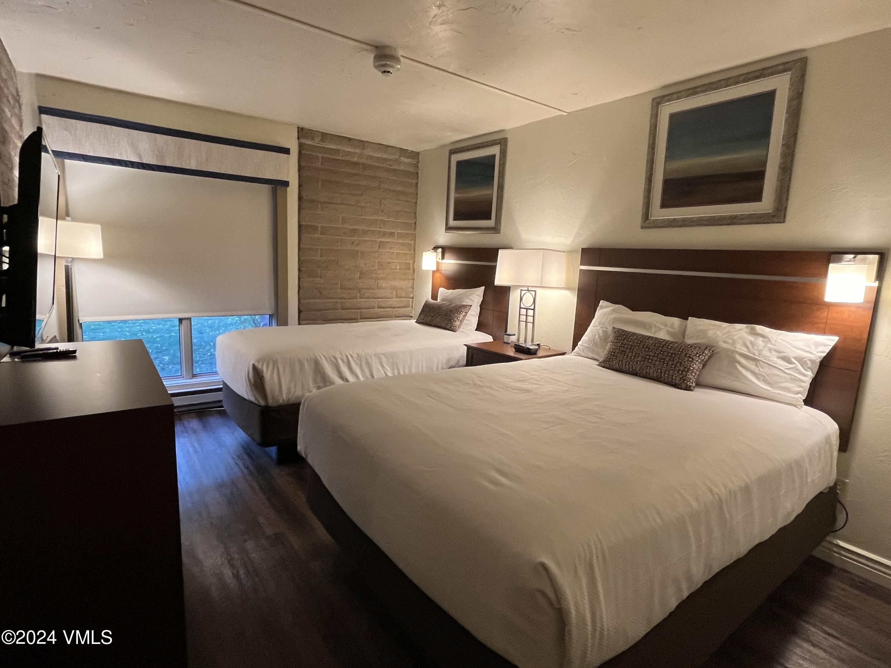 1020 Vail View Drive, Unit 310438 Vail, CO 81657 - Photo 12 of 25 a bedroom with bed and wooden floor