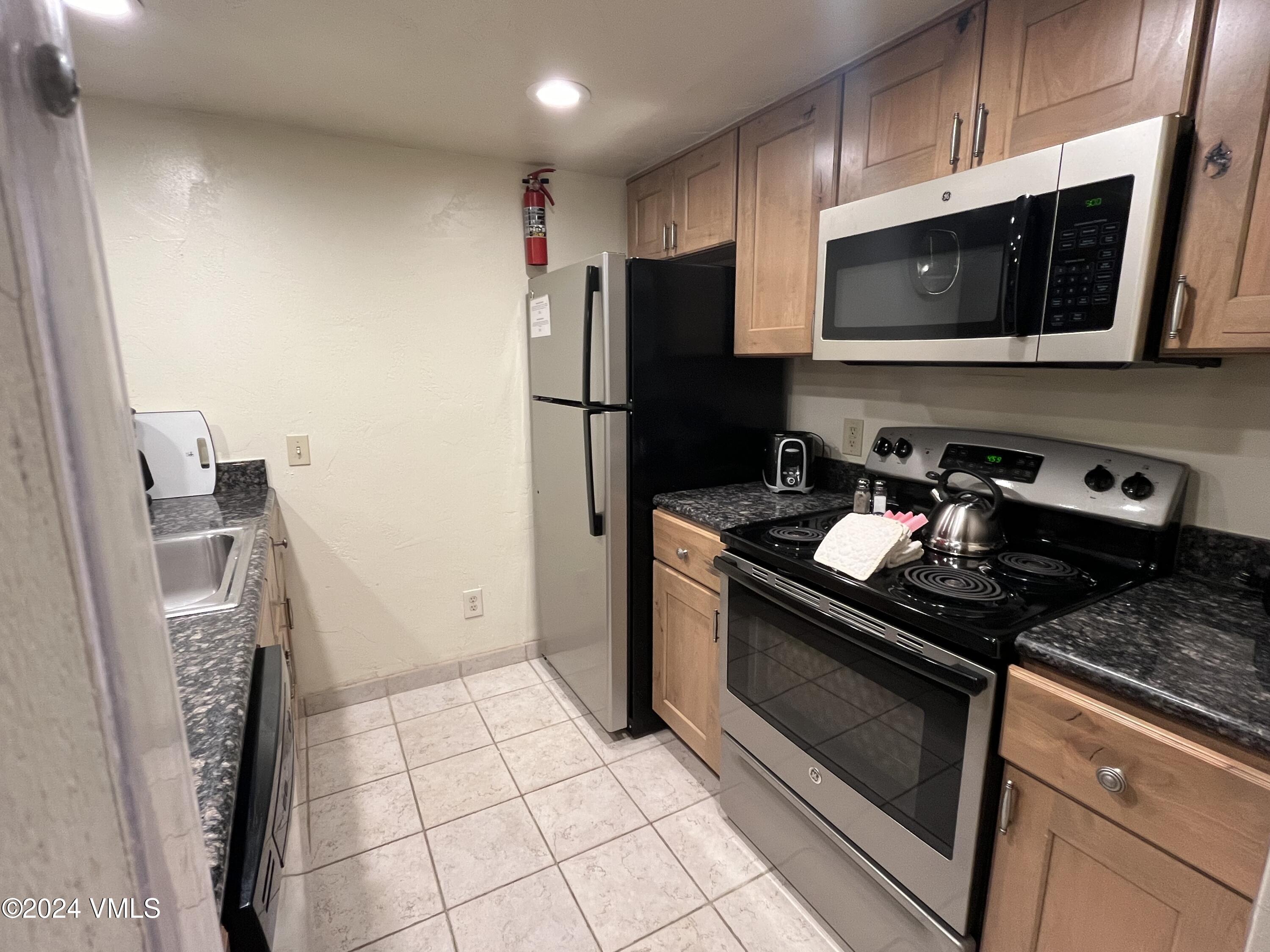 1020 Vail View Drive, Unit 310438 Vail, CO 81657 - Photo 3 of 25 a kitchen with a sink stove and refrigerator
