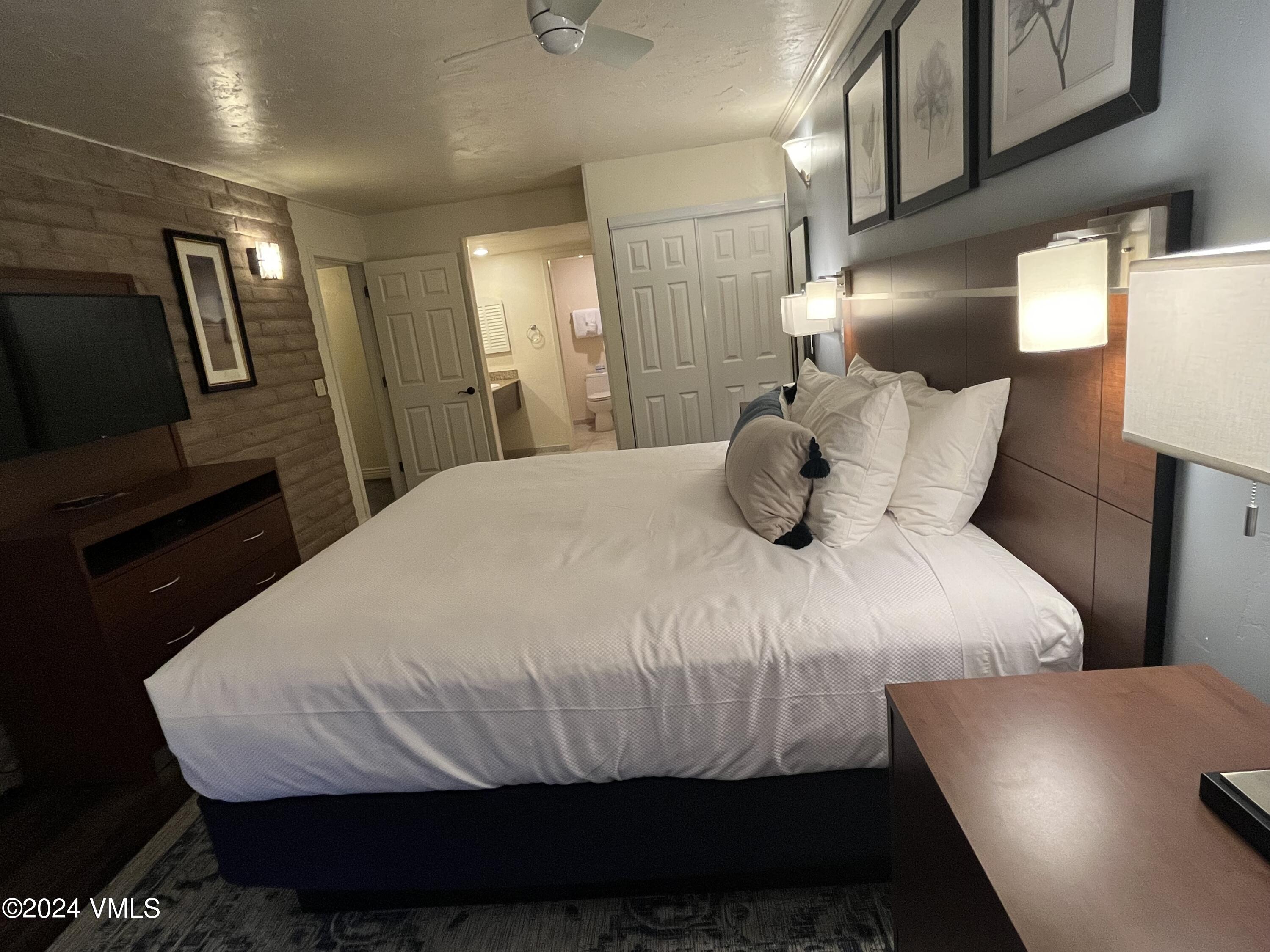 1020 Vail View Drive, Unit 310438 Vail, CO 81657 - Photo 9 of 25 a bedroom with a bed and wooden floor