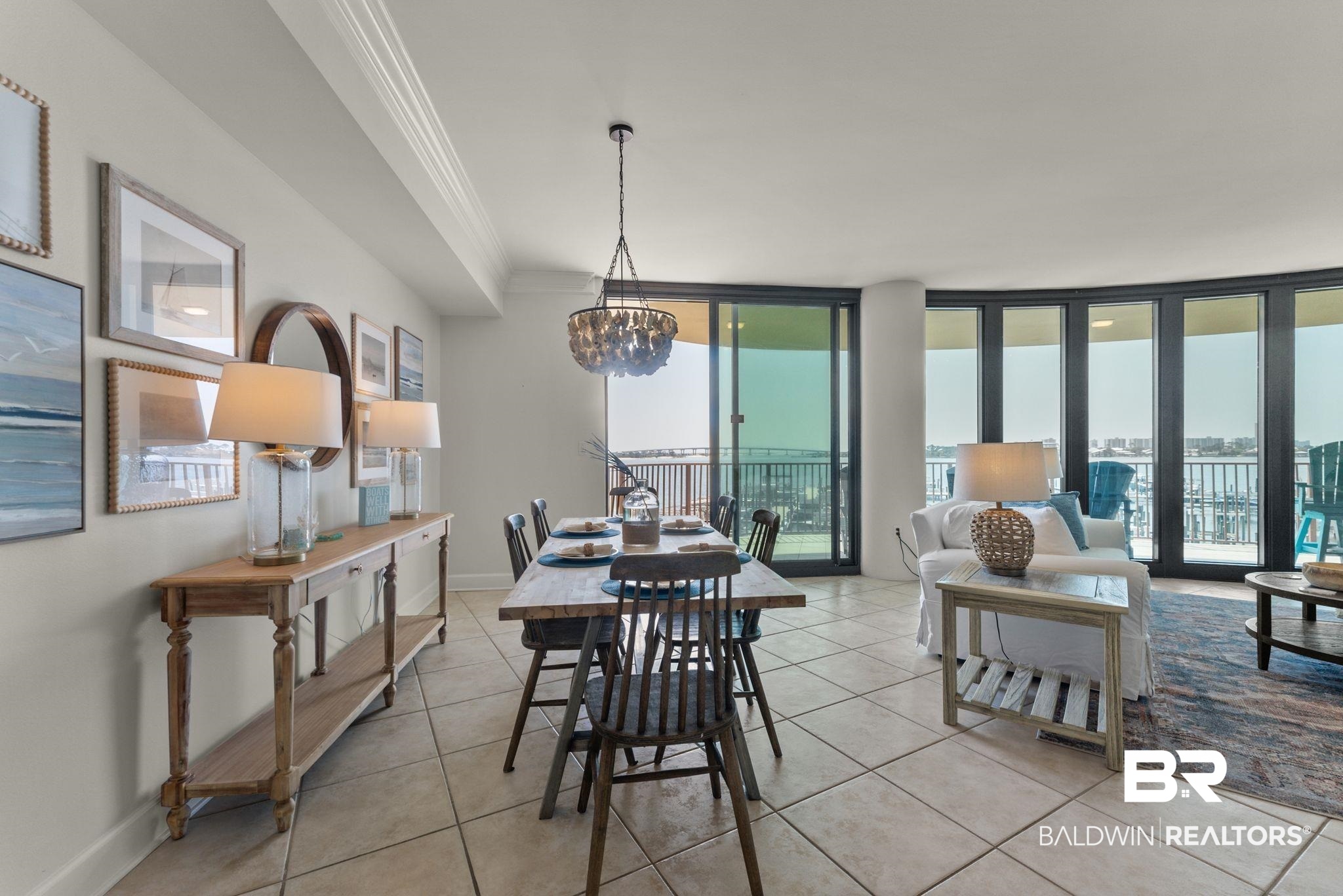 27580 Canal Road, Unit 1233 Orange Beach, AL 36561 - Photo 40 of 79 Dining room with ornamental molding, expansive windows, a chandelier, and light tile patterned floors