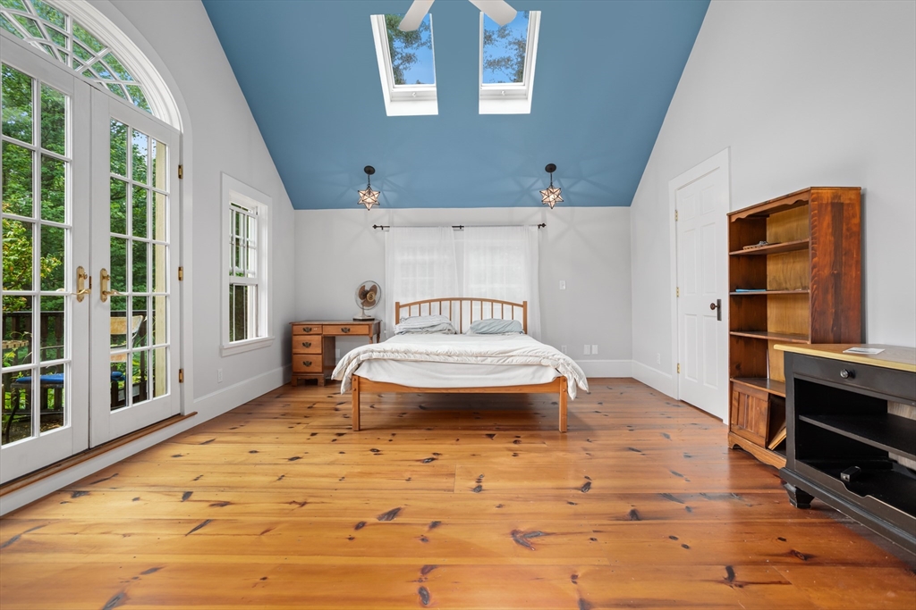 244 Lincoln Road Lincoln, MA 01773 - Photo 17 of 41 a bedroom with a bed and wooden floor