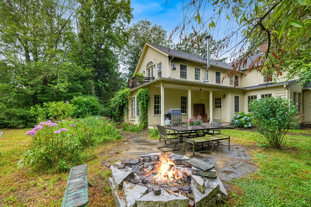 244 Lincoln Road Lincoln, MA 01773 - Photo 2 of 41 a backyard of a house with yard barbeque oven and outdoor seating