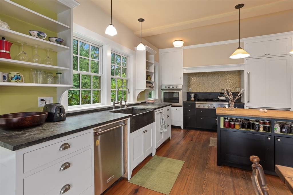 244 Lincoln Road Lincoln, MA 01773 - Photo 8 of 41 a kitchen with stainless steel appliances granite countertop a sink a stove and a wooden floors