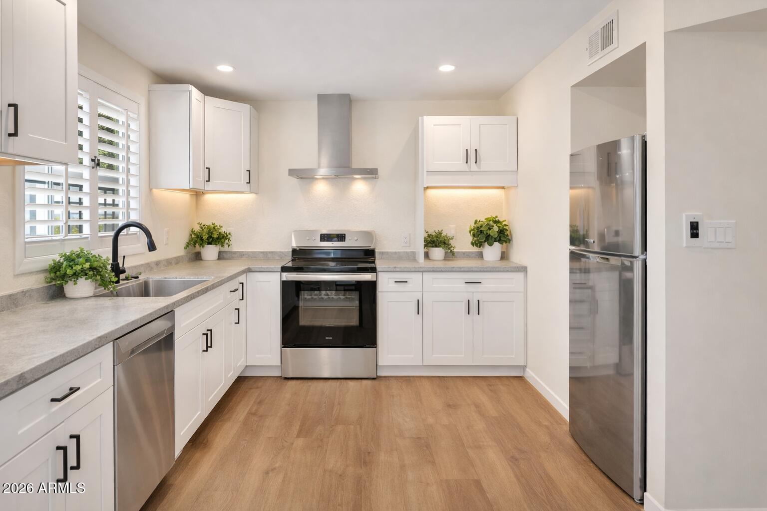 a kitchen with white cabinets and white appliances