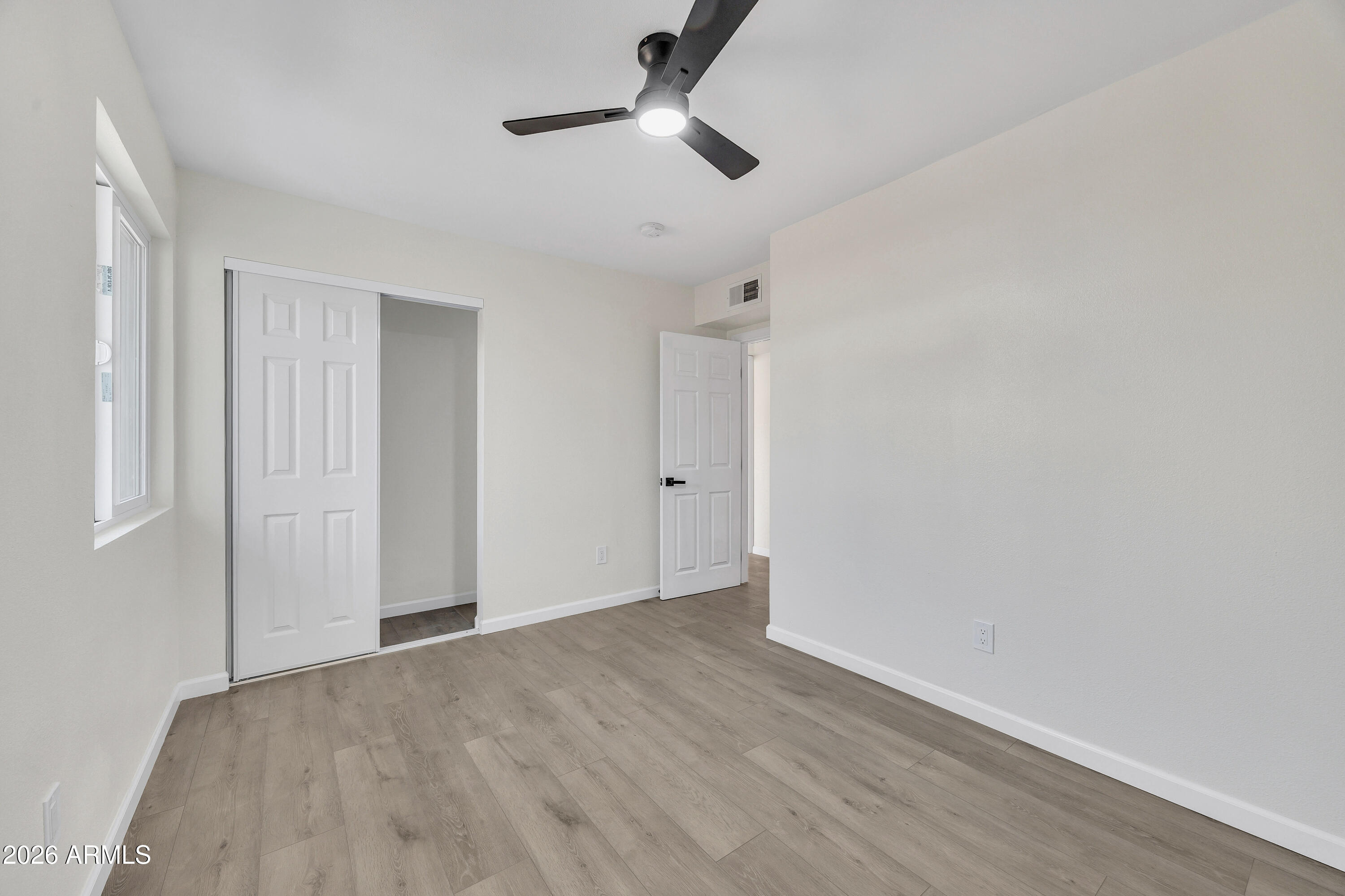 6735 North 16th Street, Unit 4 Phoenix, AZ 85016 - Photo 18 of 27 a view of empty room with wooden floor