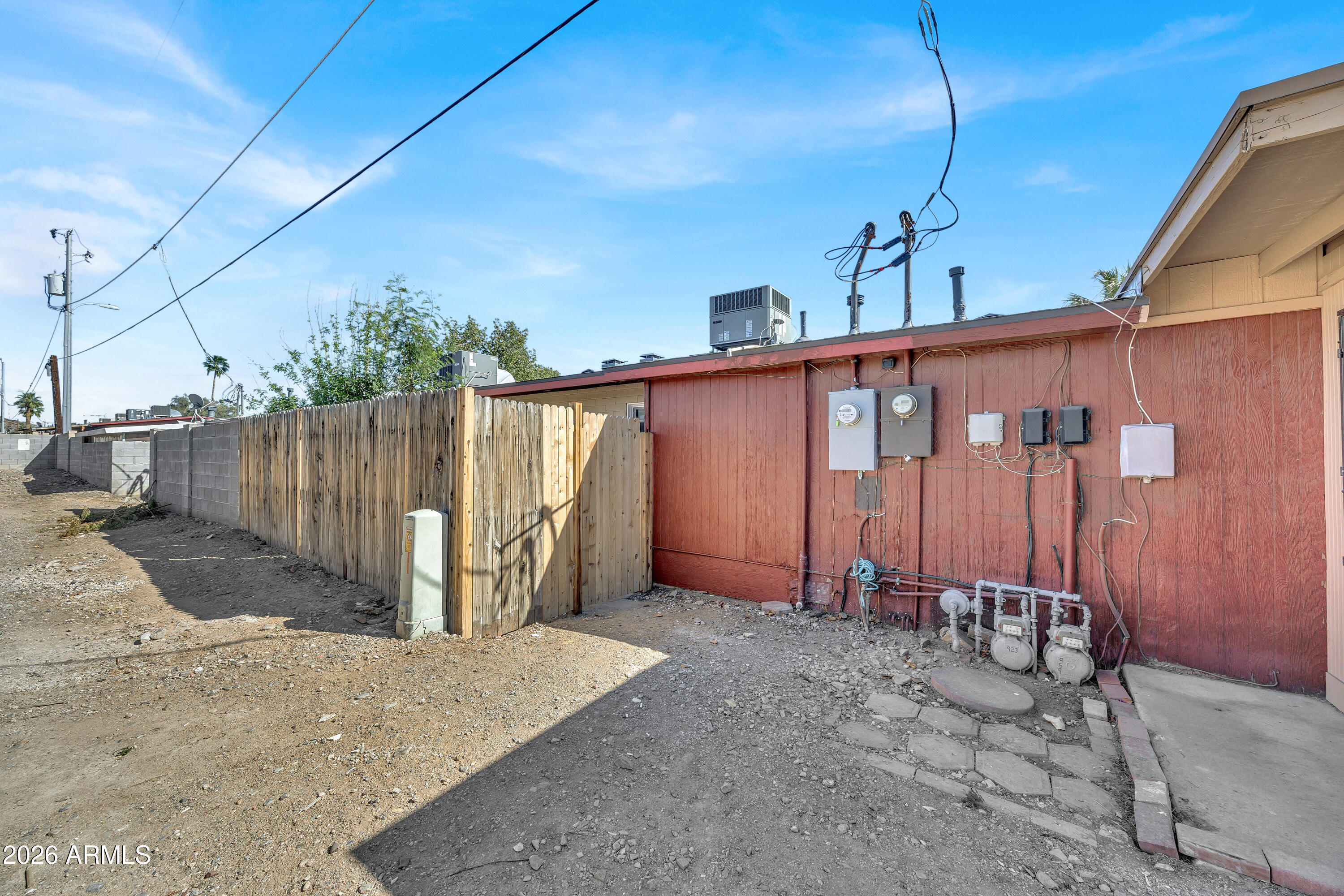 6735 North 16th Street, Unit 4 Phoenix, AZ 85016 - Photo 22 of 27 a view of a blue house with wooden fence