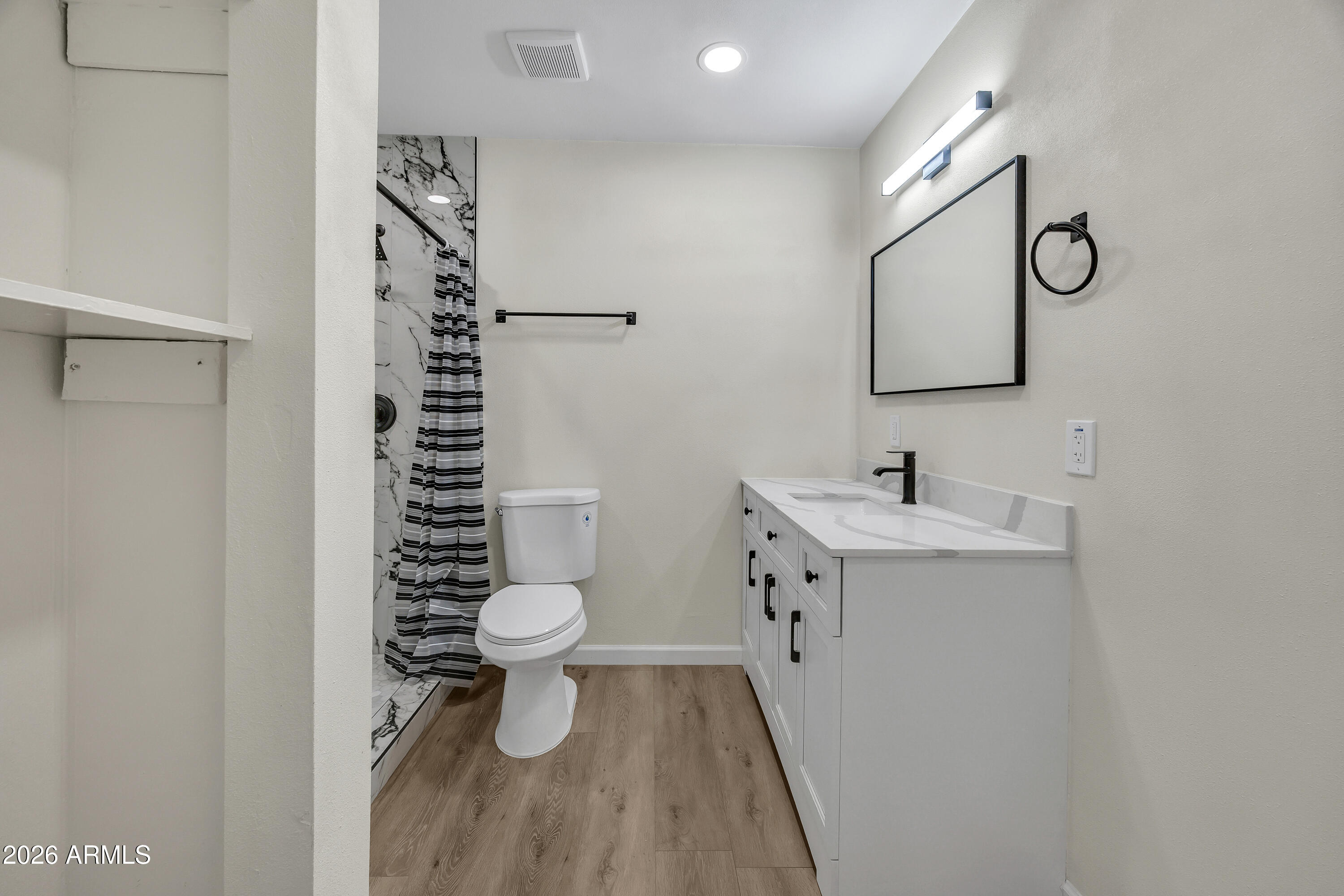 6735 North 16th Street, Unit 4 Phoenix, AZ 85016 - Photo 9 of 27 a bathroom with a sink toilet and shower