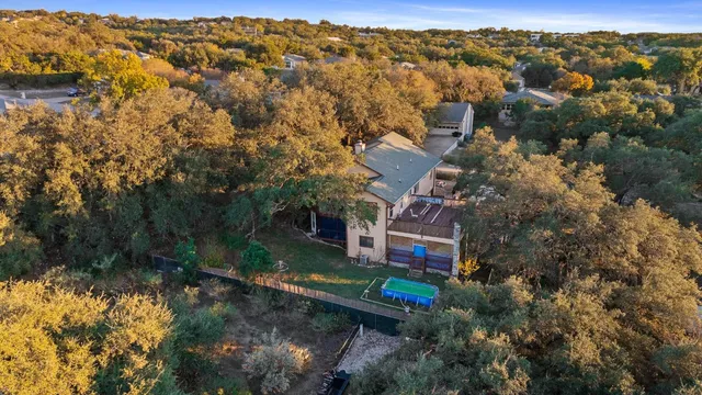 an aerial view of a house with a yard