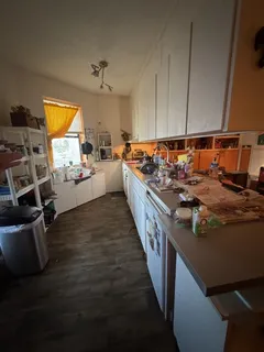 a kitchen with sink refrigerator and stove top oven