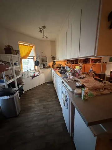 a kitchen with sink refrigerator and stove top oven
