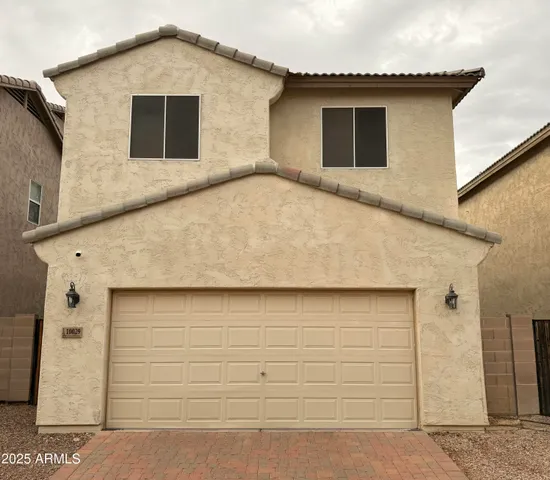 a front view of a house with garage