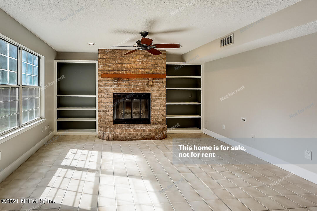 328 North Ridge Drive Orange Park, FL 32003 - Photo 16 of 33 a view of an empty room with a fireplace and a window
