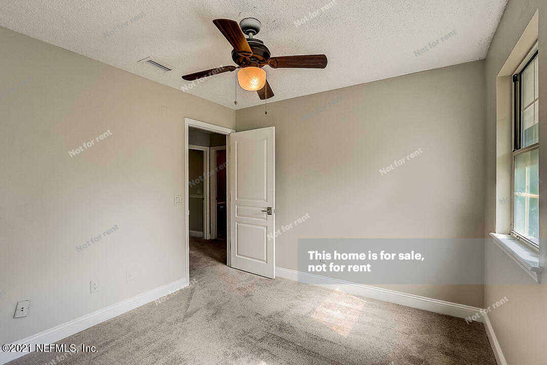 328 North Ridge Drive Orange Park, FL 32003 - Photo 22 of 33 a view of a hallway with a ceiling fan and window