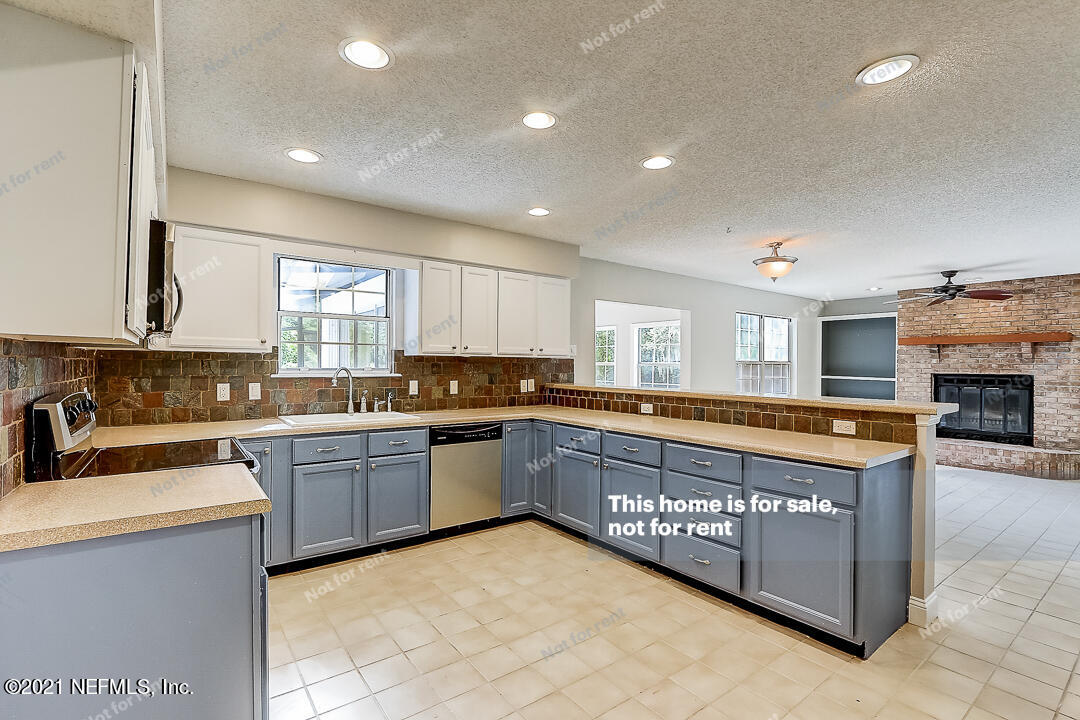 328 North Ridge Drive Orange Park, FL 32003 - Photo 4 of 33 a large kitchen with stainless steel appliances granite countertop a stove and a sink