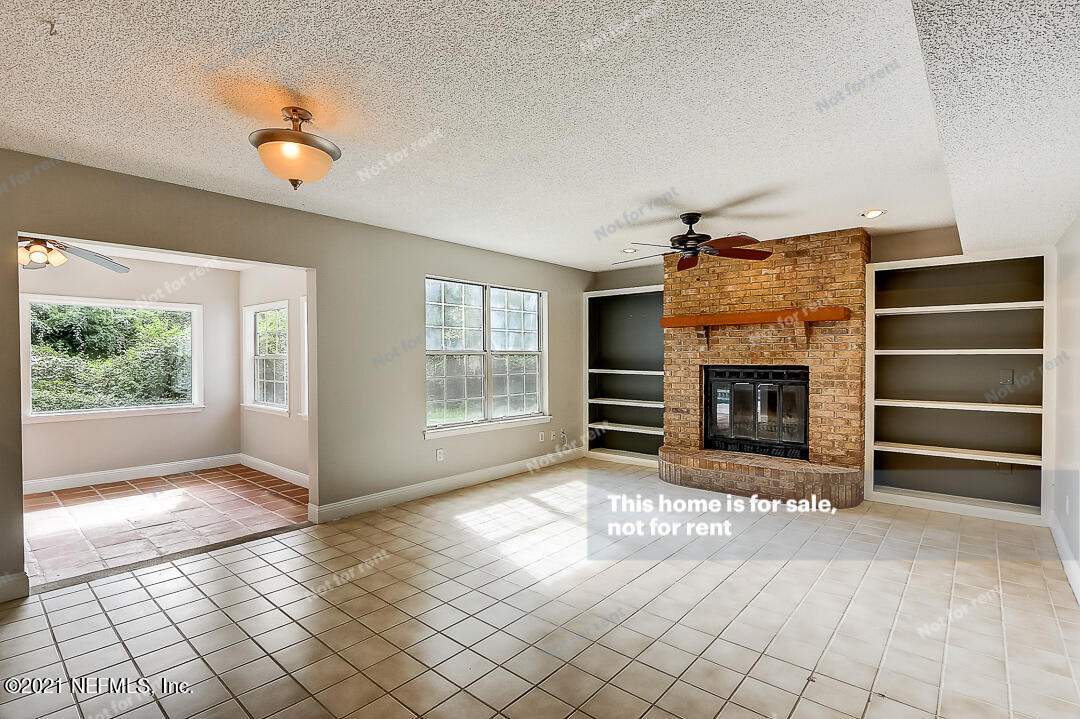 328 North Ridge Drive Orange Park, FL 32003 - Photo 6 of 33 a view of an empty room with a fireplace and window